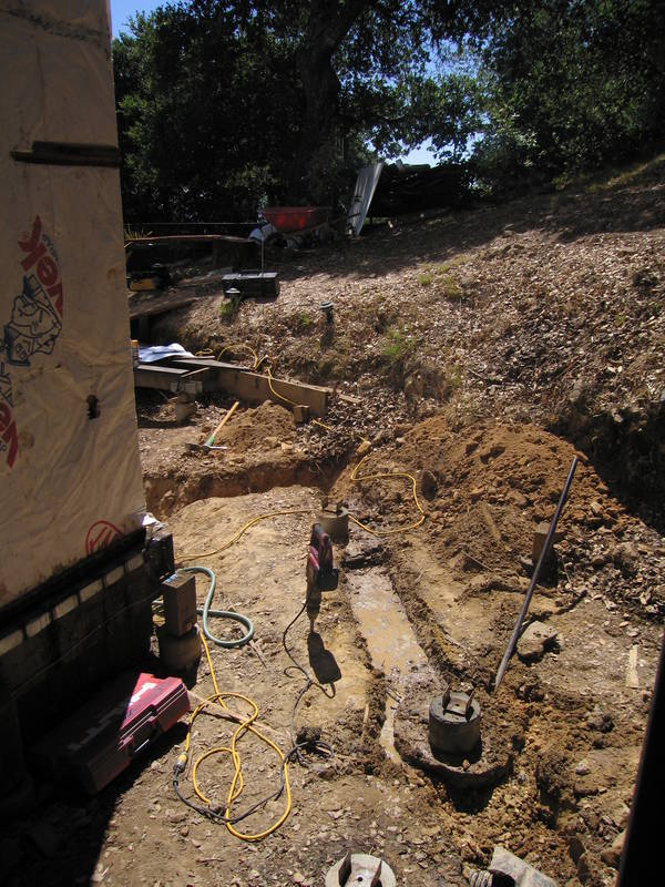 Trenching, by hand, of the footings for...