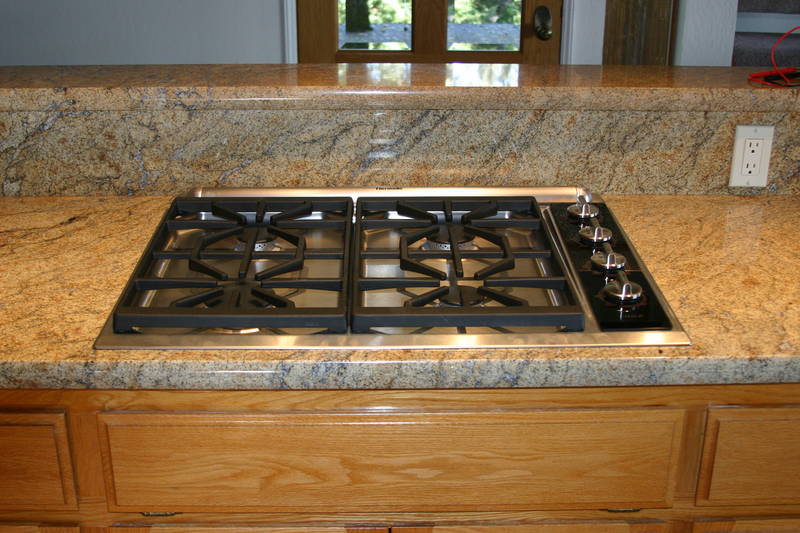The Wolf cooktop and Thermador hurricane-force downdraft in place.